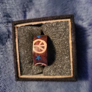 Wood painted ring with peace symbols and stars.